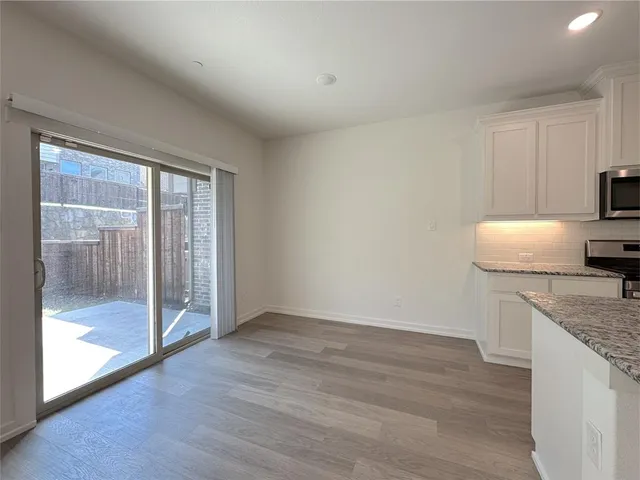 a kitchen with granite countertop a sink and a stove top oven