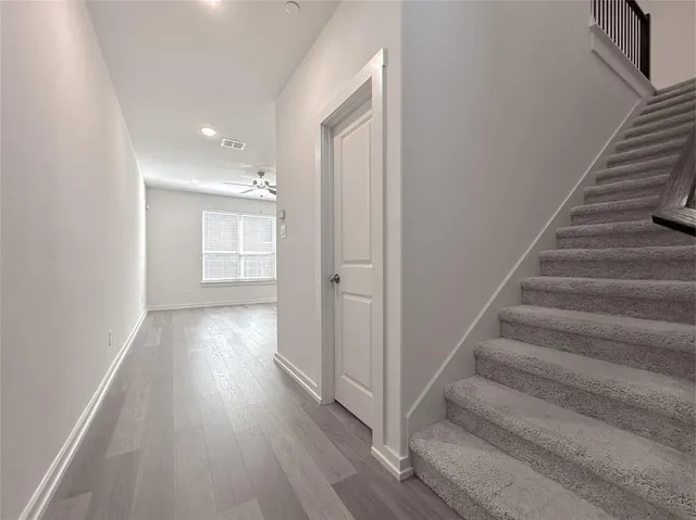 a view of an entryway with wooden floor