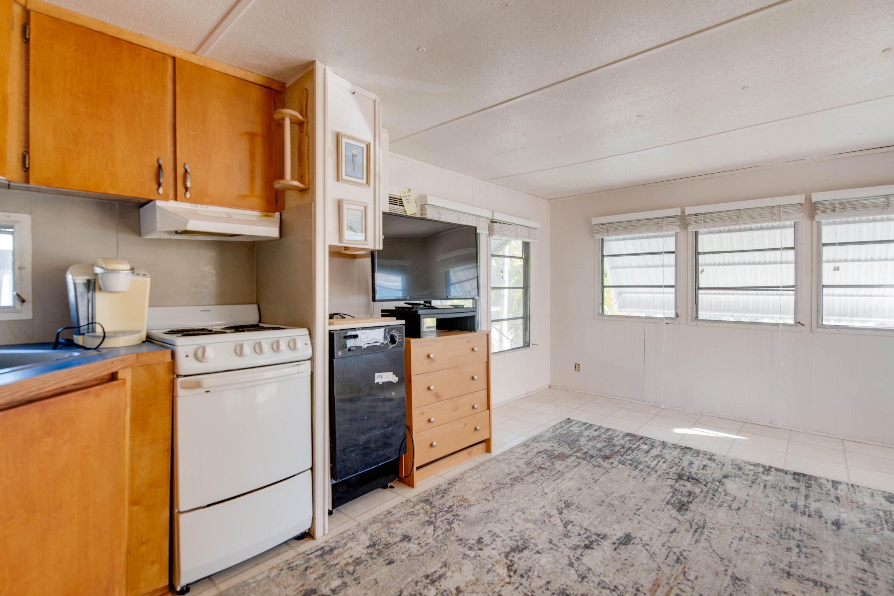 138 Sands Road Big Pine Key, FL 33043 - Photo 3 of 18 a kitchen with a stove a sink and a refrigerator