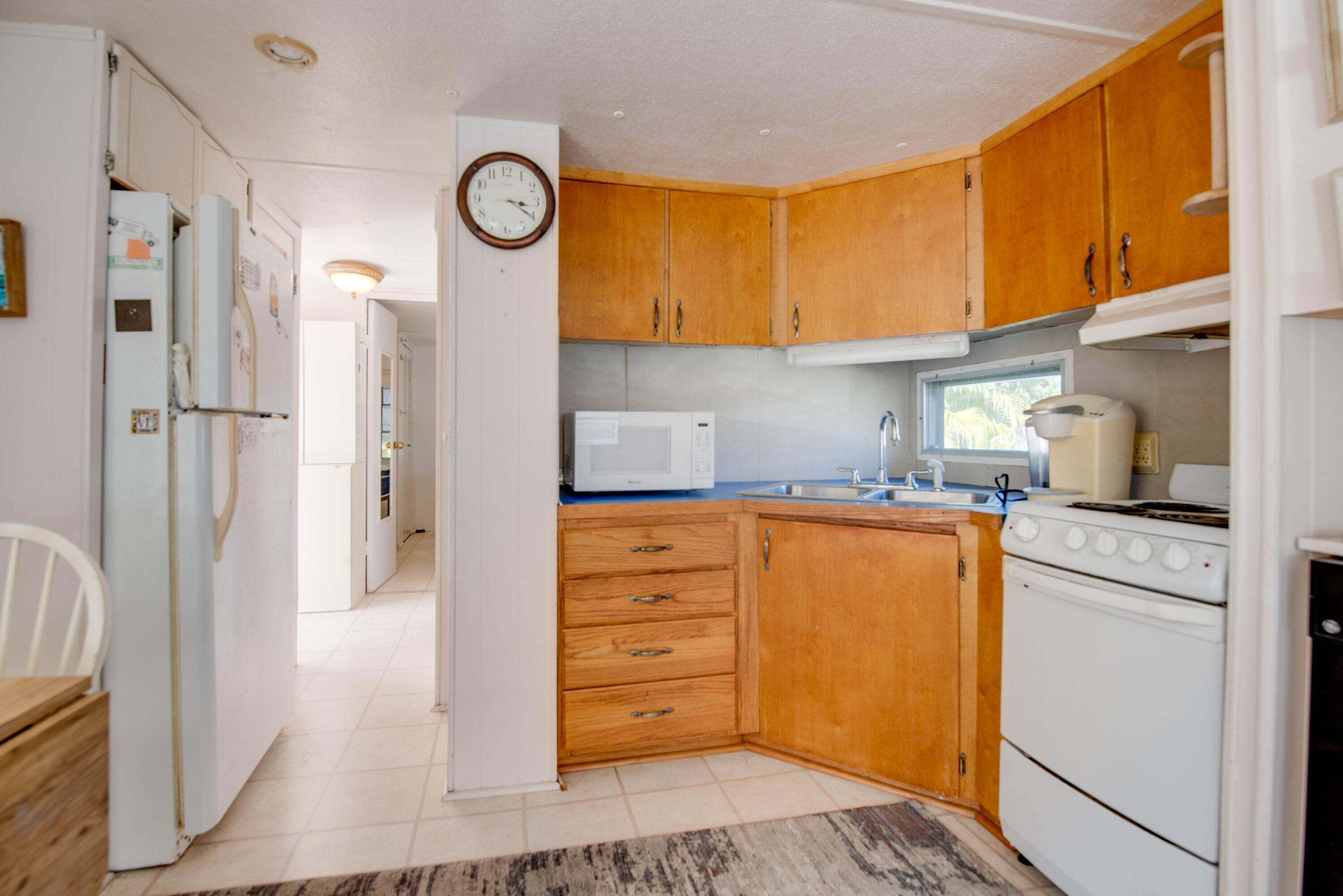 138 Sands Road Big Pine Key, FL 33043 - Photo 6 of 18 a kitchen with stainless steel appliances granite countertop a refrigerator and a stove
