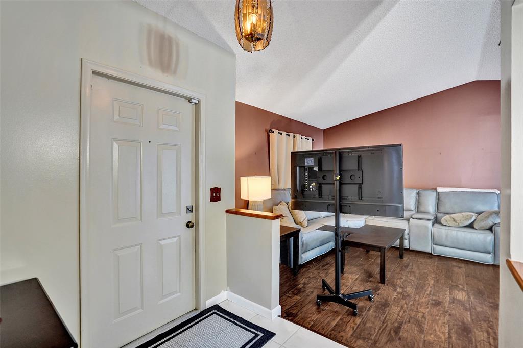 9132 Southwest 20th Street, Unit B Boca Raton, FL 33428 - Photo 12 of 81 a living room with furniture a window and gym equipment