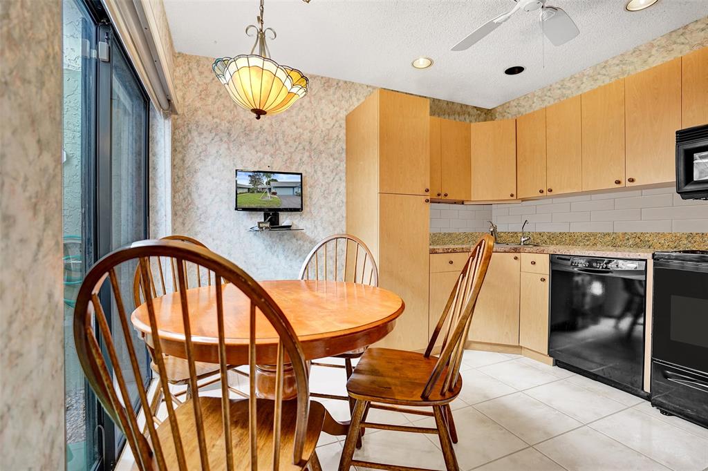 9132 Southwest 20th Street, Unit B Boca Raton, FL 33428 - Photo 14 of 81 a dinning room with a table and chairs