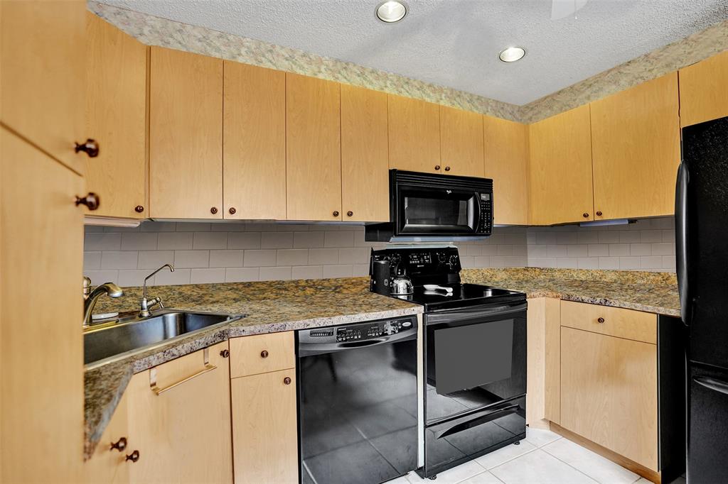 9132 Southwest 20th Street, Unit B Boca Raton, FL 33428 - Photo 17 of 81 a kitchen with a sink a stove and cabinets