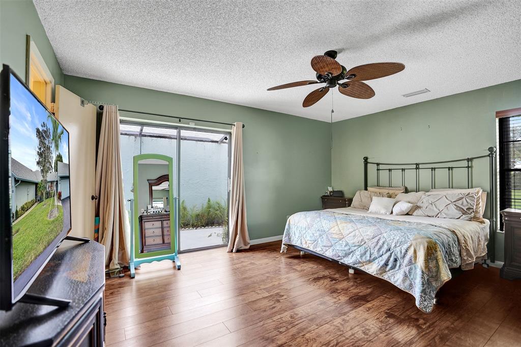 9132 Southwest 20th Street, Unit B Boca Raton, FL 33428 - Photo 23 of 81 a bedroom with a bed and a flat screen tv