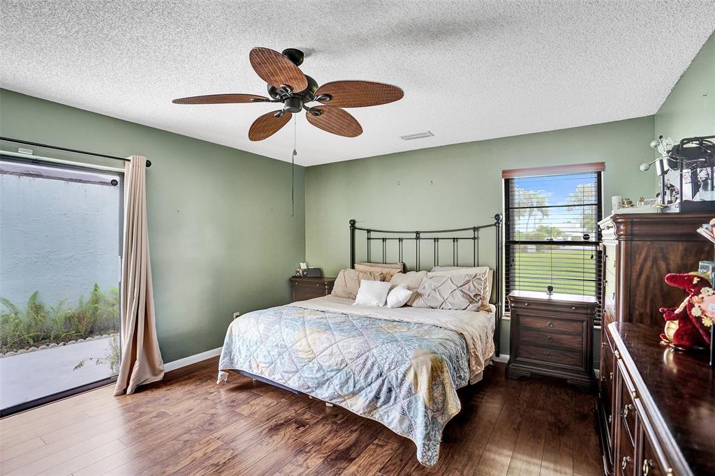 9132 Southwest 20th Street, Unit B Boca Raton, FL 33428 - Photo 24 of 81 a bedroom with a bed and a flat screen tv