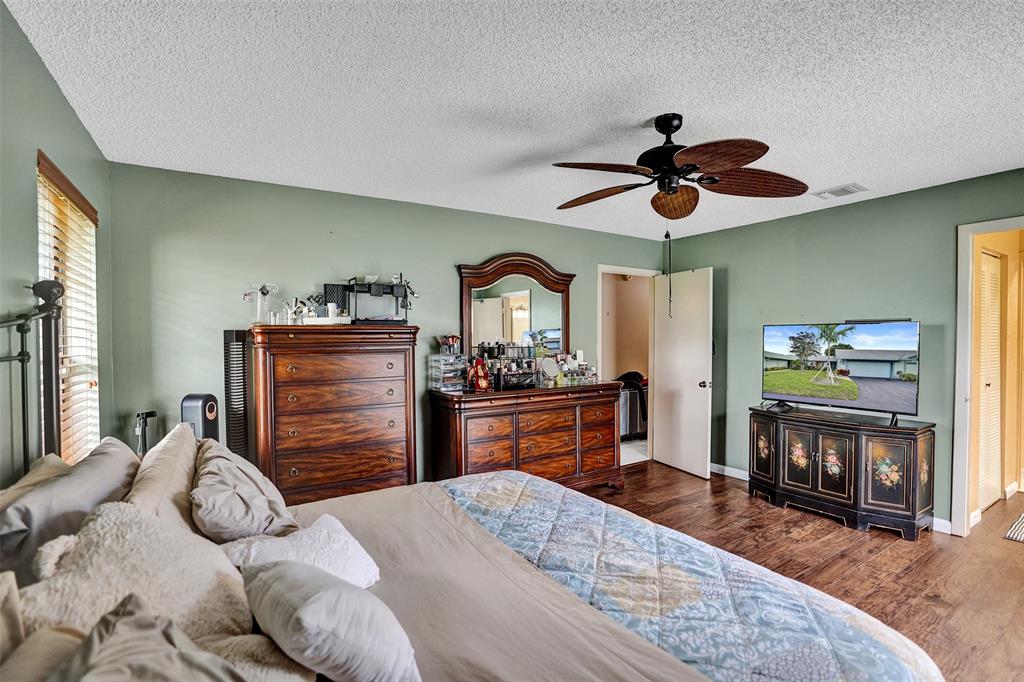 9132 Southwest 20th Street, Unit B Boca Raton, FL 33428 - Photo 26 of 81 a bedroom with a bed and a chandelier