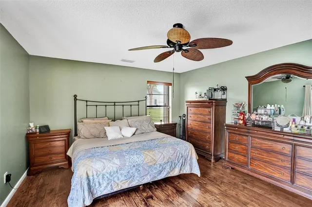 a bed sitting in a bedroom next to a window