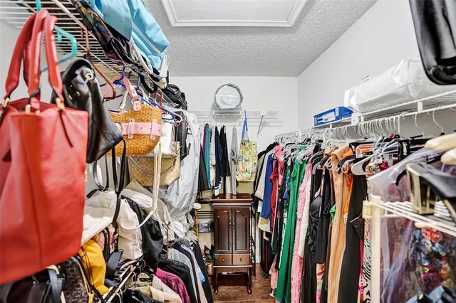 a bedroom with a bed and dresser with mirror