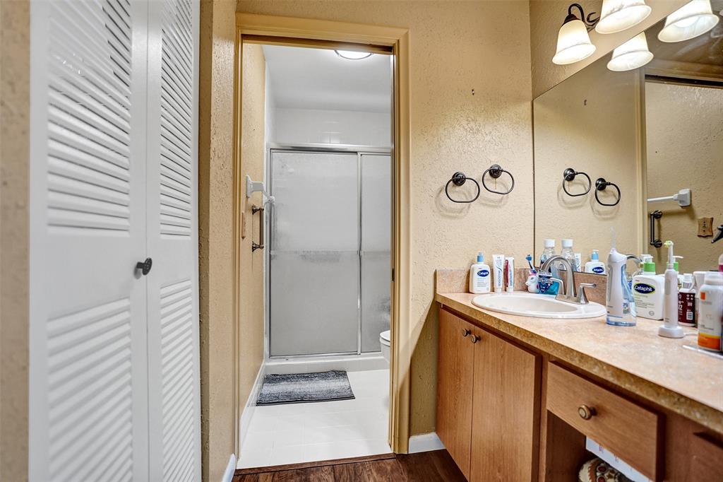 9132 Southwest 20th Street, Unit B Boca Raton, FL 33428 - Photo 30 of 81 a bathroom with a sink a mirror and shower