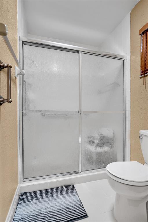 9132 Southwest 20th Street, Unit B Boca Raton, FL 33428 - Photo 33 of 81 a bathroom with a shower and a toilet