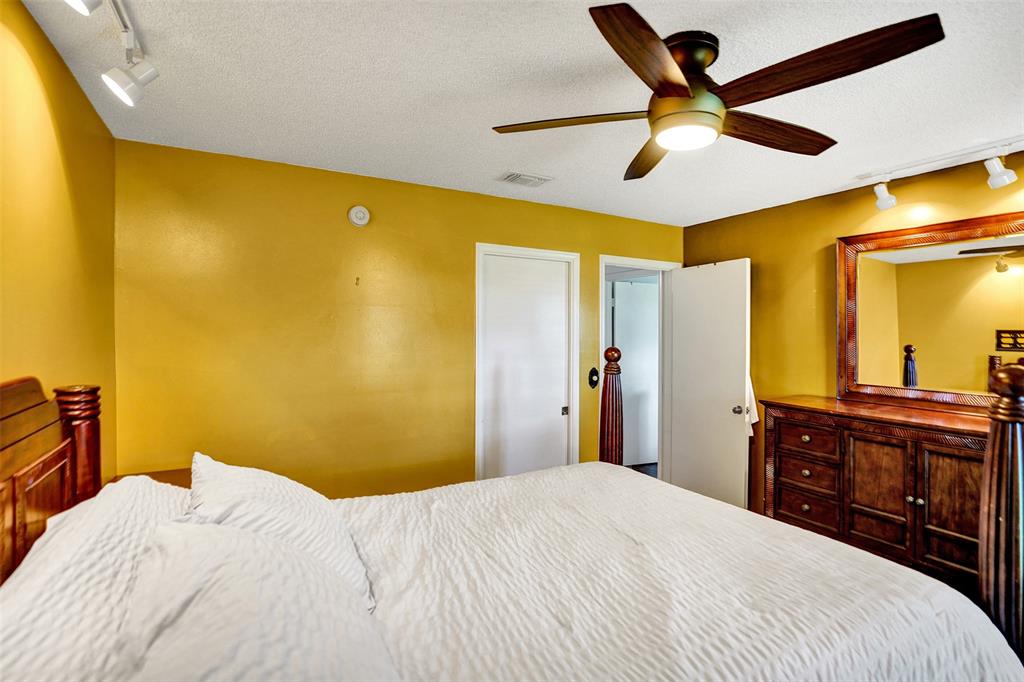 9132 Southwest 20th Street, Unit B Boca Raton, FL 33428 - Photo 36 of 81 a bedroom with a bed and a chandelier