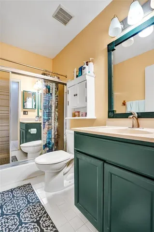 a backyard of a house with plants and wooden fence