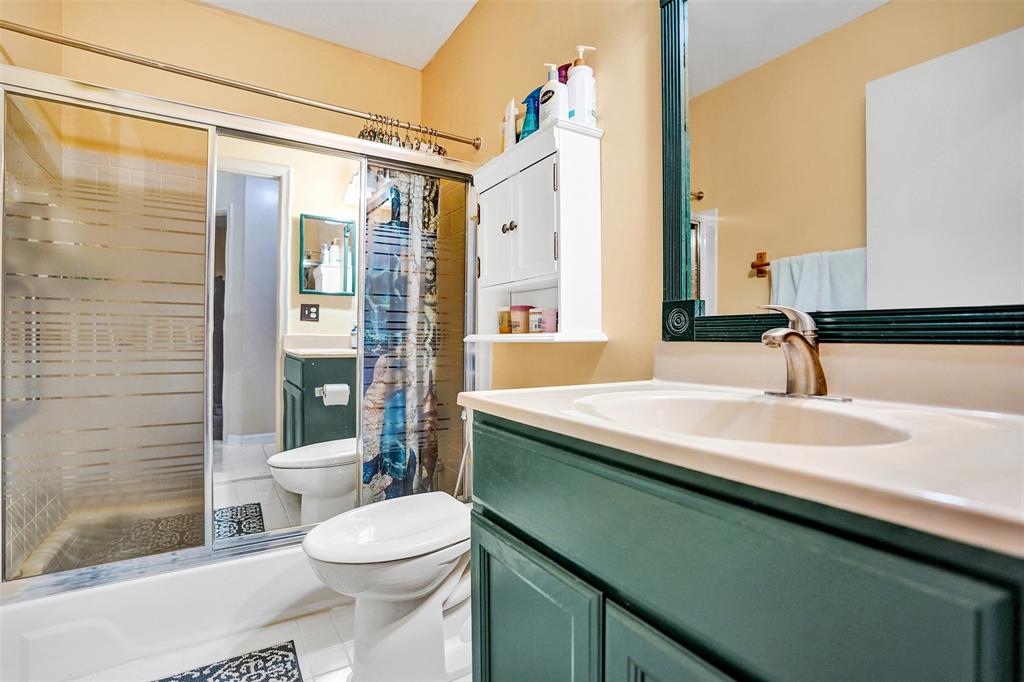 9132 Southwest 20th Street, Unit B Boca Raton, FL 33428 - Photo 40 of 81 a bathroom with a sink a toilet a mirror and shower