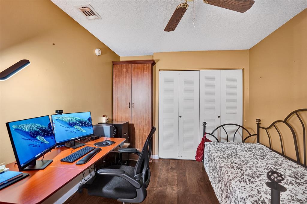 9132 Southwest 20th Street, Unit B Boca Raton, FL 33428 - Photo 41 of 81 a bedroom with a bed and wooden floor