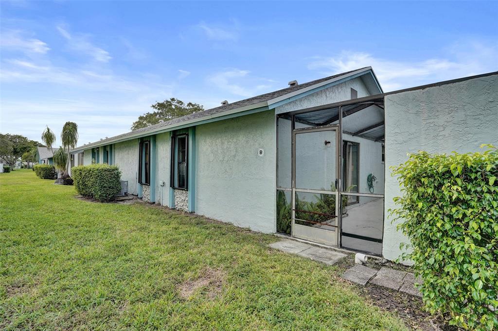 9132 Southwest 20th Street, Unit B Boca Raton, FL 33428 - Photo 53 of 81 a backyard of a house with plants and wooden fence