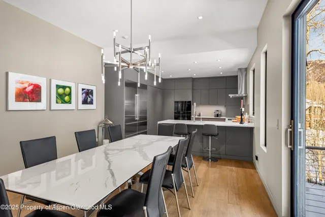 a large kitchen with a table and chairs