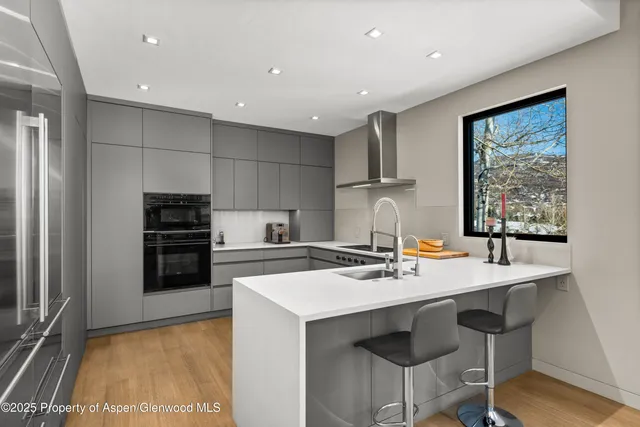 a kitchen with a stove a refrigerator and a stove top oven