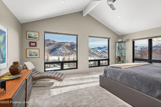 a bedroom with a large bed and a large window