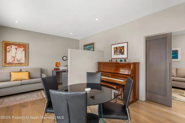 a dining room with furniture and wooden floor