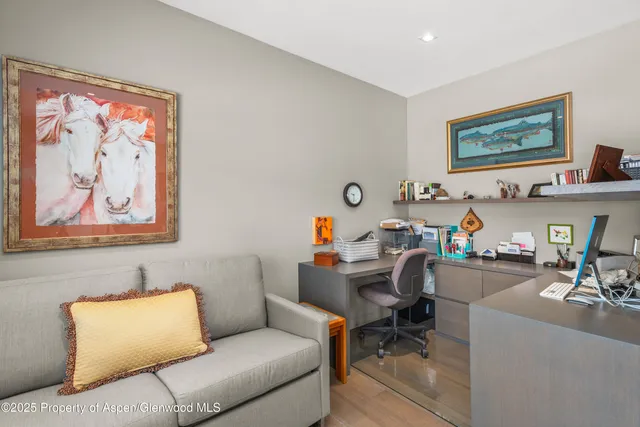 a living room with furniture and painting on the wall