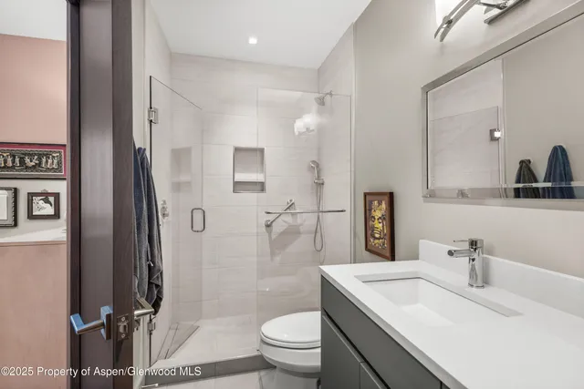 a bathroom with a sink toilet and shower