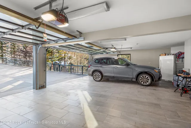 a view of parking garage with a car parked in it