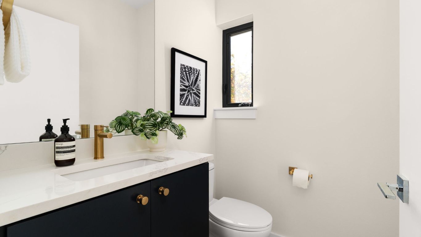 3813 Tilley Street Austin, TX 78723 - Photo 12 of 26 a bathroom with a sink a toilet and mirror