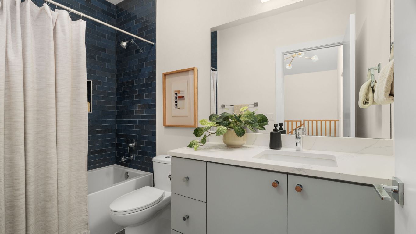 3813 Tilley Street Austin, TX 78723 - Photo 16 of 26 a bathroom with a granite countertop sink toilet and shower