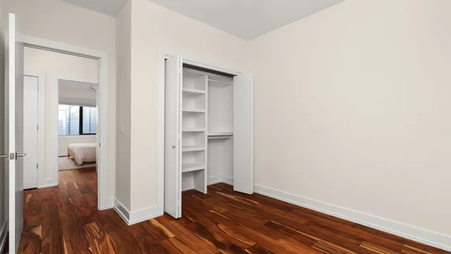 a view of a room with wooden floor and bedroom view