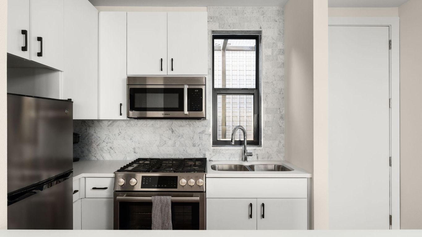 3813 Tilley Street Austin, TX 78723 - Photo 21 of 26 a kitchen with stainless steel appliances granite countertop a stove a sink and a microwave