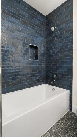 a bathroom with a bathtub and a shower