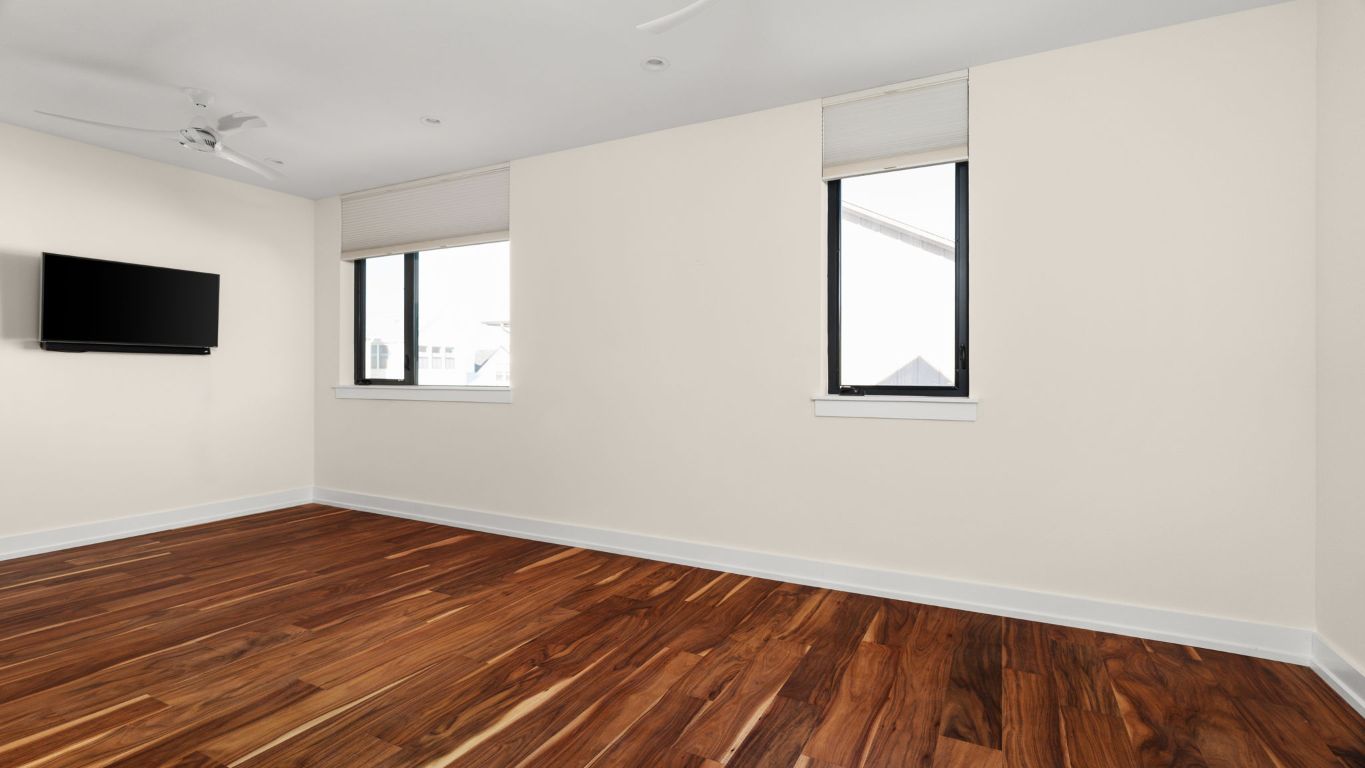 3813 Tilley Street Austin, TX 78723 - Photo 24 of 26 an empty room with wooden floor and windows