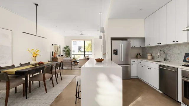 a large kitchen with kitchen island a table and chairs