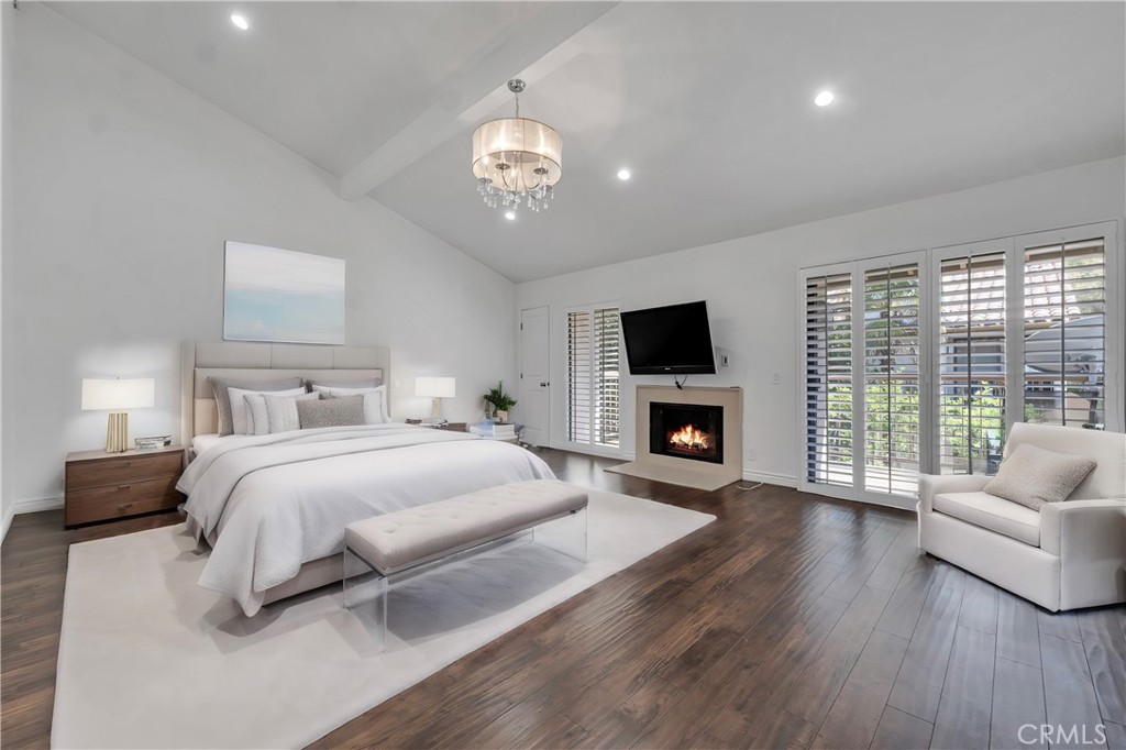 a spacious bedroom with a large bed and a fireplace