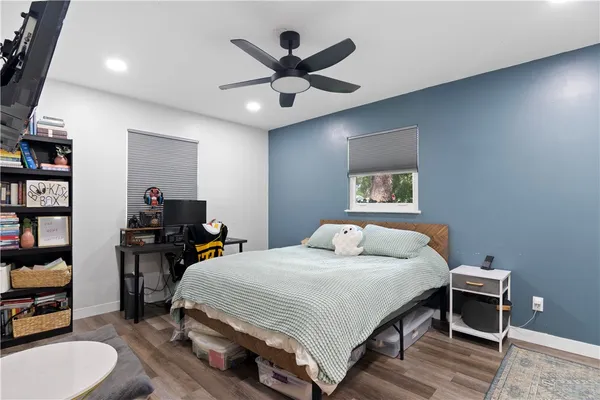 a bedroom with a bed and a bookshelf