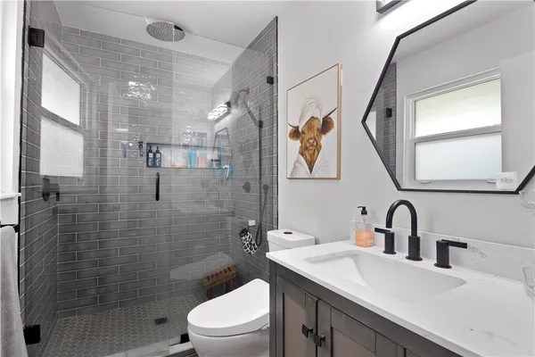 a bathroom with a sink toilet and shower