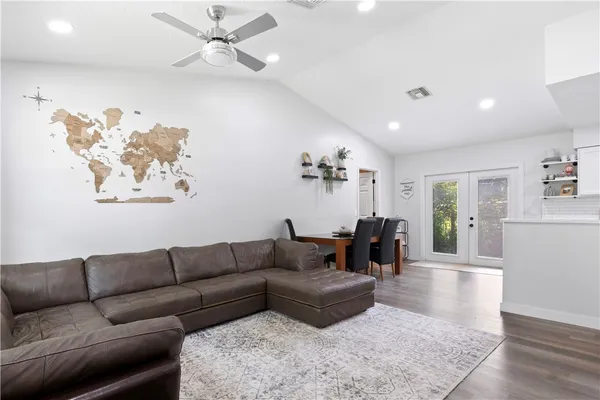 a living room with furniture and wooden floor