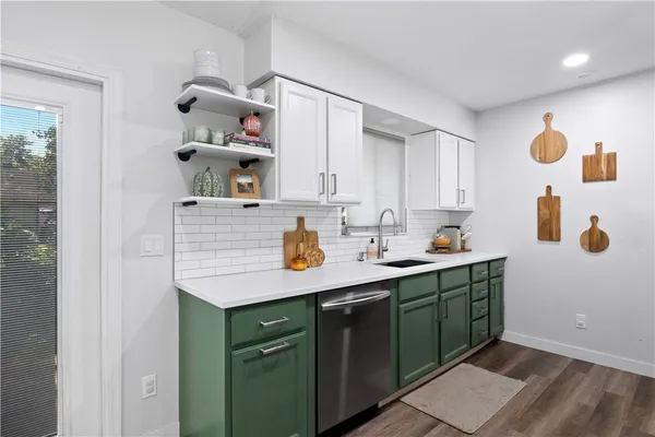 a kitchen with a sink and cabinets