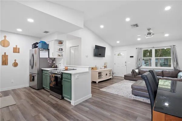 a kitchen with stainless steel appliances kitchen island granite countertop a stove and a refrigerator