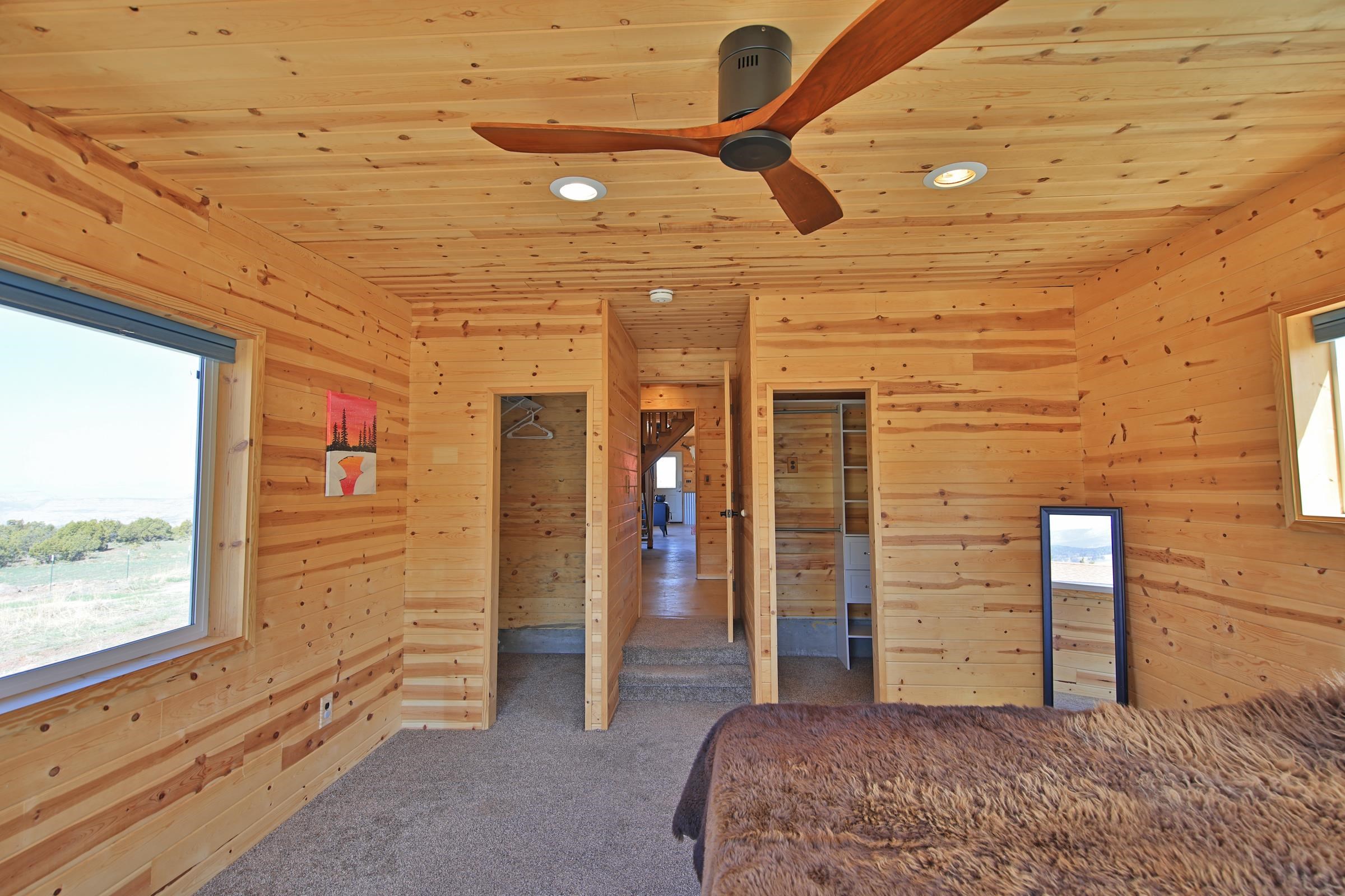 56001 KK Road Molina, CO 81646 - Photo 15 of 42 a bedroom with a bed and a ceiling fan