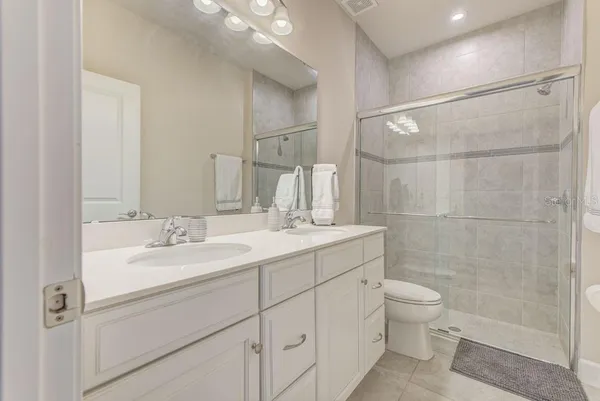 a hall way with furniture a mirror and wooden floor