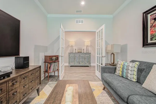 a view of a hallway with wooden floor and closet