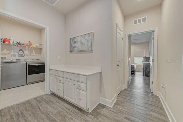 a bathroom with a toilet a sink a mirror a shower a vanity and window