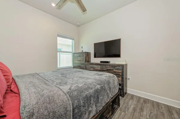 a bedroom with a bed and a flat screen tv