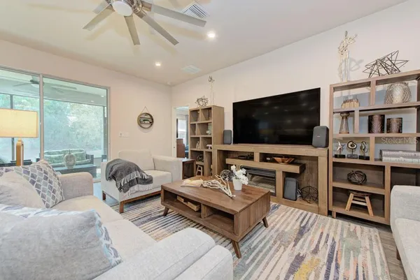 a open kitchen with stainless steel appliances granite countertop a refrigerator and chairs