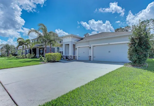 a front view of a house with a yard and a garage