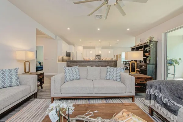 a large kitchen with cabinets table and chairs