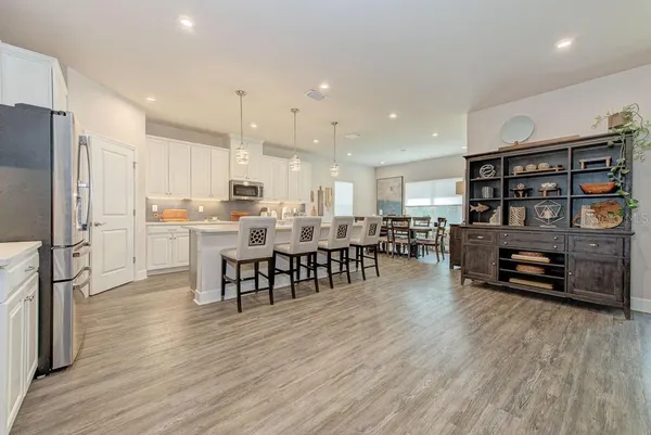 a large kitchen with a table and chairs