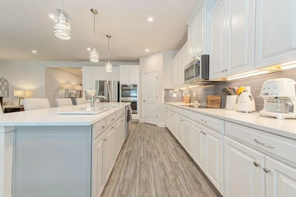 a bedroom with a bed wooden floor and window