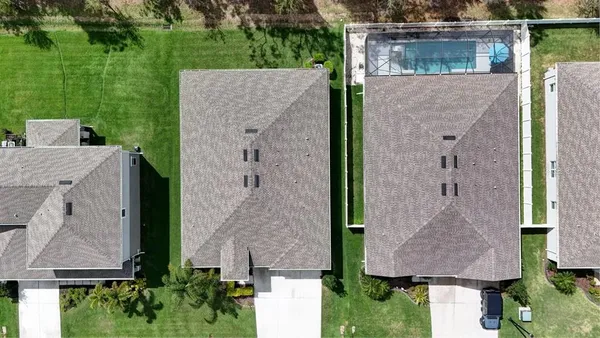 an aerial view of residential houses with outdoor space